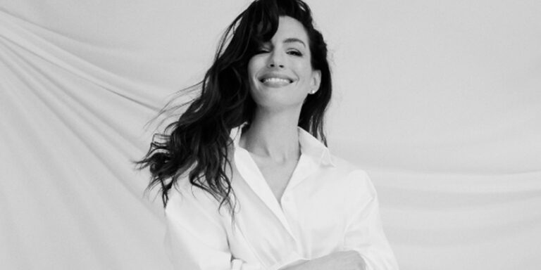 Anne hathaway sported a white button up shirt.