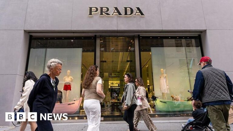 Prada acquires Versace at a reduced price.